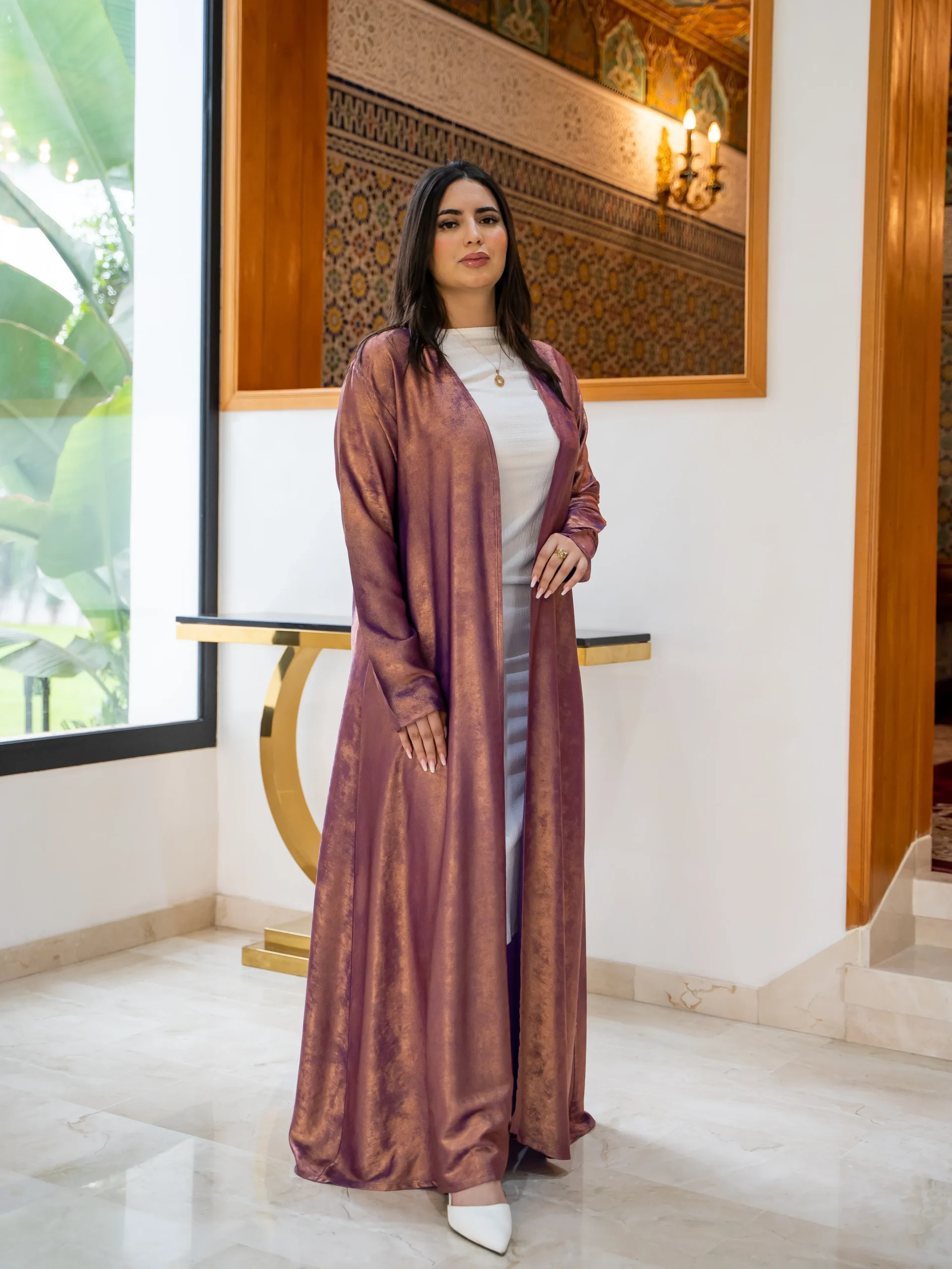 Woman wearing a mauve shimmer open abaya with inner dress — Maisam Luxury Abaya Collection.